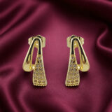 Pair of gold-tone open triangular stud earrings with tapered clear-stone detailing on a white background.